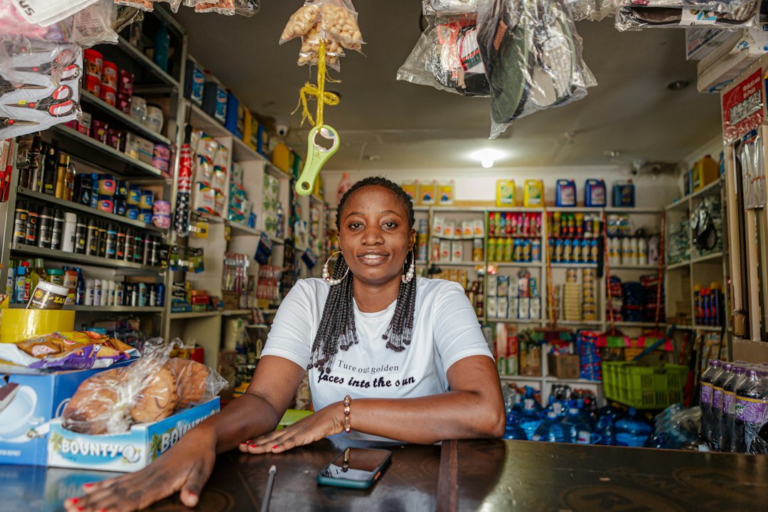 African small business owner inside a small shop, illustrative image.