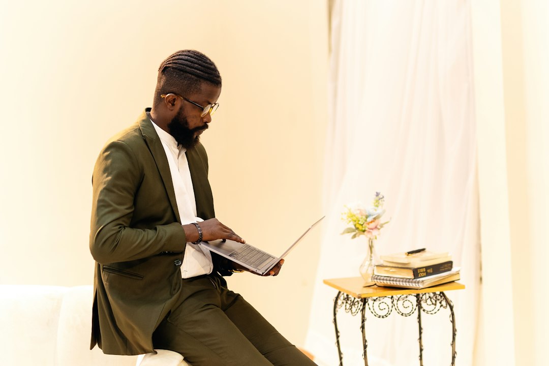 Illustrative image of a Nigerian business professional working at a laptop; photo by Ninthgrid via Unsplash